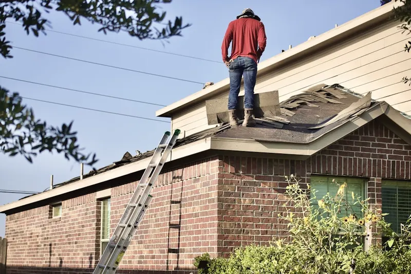 Professional roofer working on a residential roof in Villa Magnolia Mobile Home Park